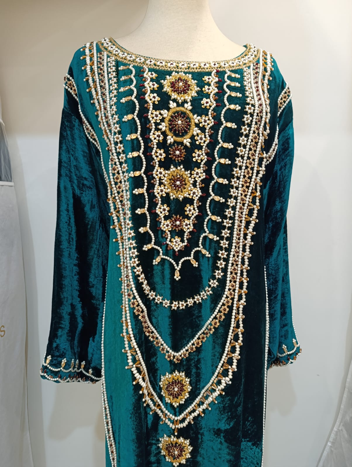 Emerald green velvet abaya with intricate pearl and gold bead embroidery